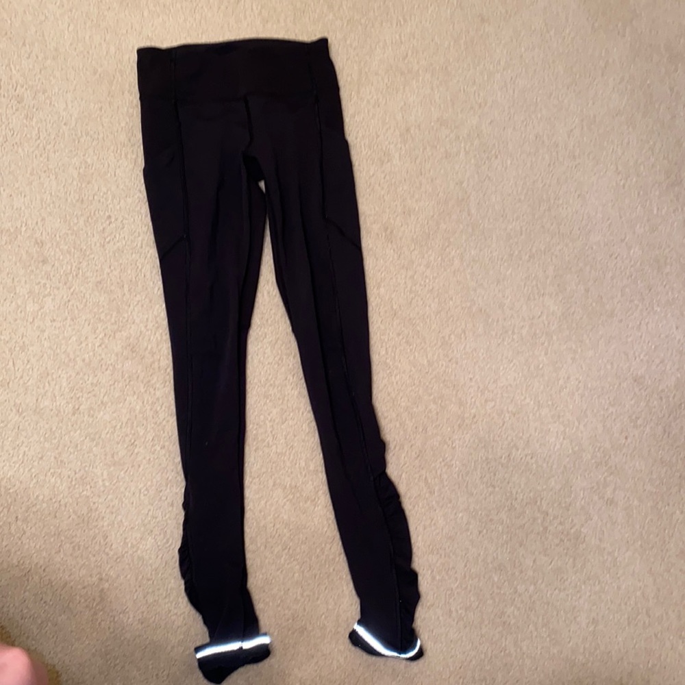 Reflective bottom black lululemon leggings w pockets and ruffles on the side